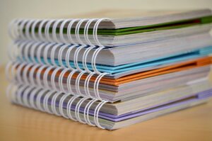 A stack of binders representing an estate plan.